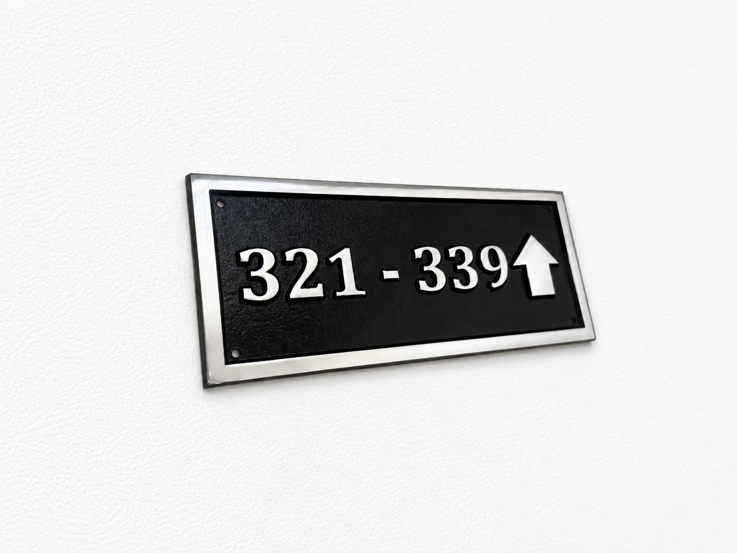 Cast aluminium directional sign with custom text and arrow for hotel or office wayfinding