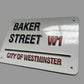 Metal sign with 'Baker Street W1' and 'City of Westminster' text on a white background