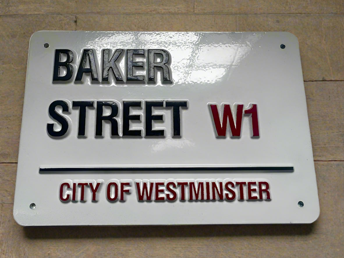 Metal sign with 'Baker Street W1' and 'City of Westminster' text on a white background