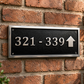 Cast aluminium directional sign with custom text and arrow for hotel or office wayfinding