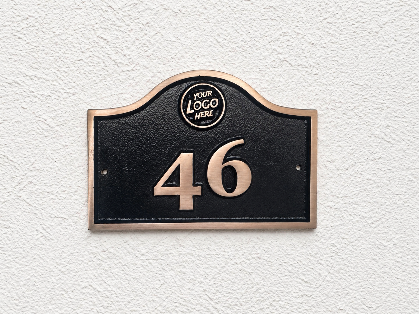 Cast bronze hotel room number sign with custom logo and raised numbers mounted on wall