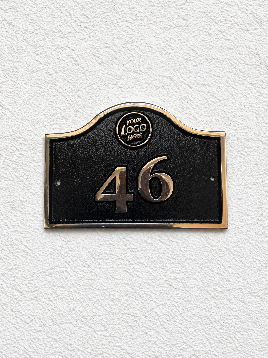 Cast bronze hotel room number sign with custom logo and raised numbers mounted on wall