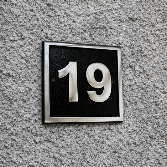 Cast aluminium square house number sign with raised polished numerals black background and background fixing holes