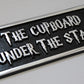 the cupboard under the stairs sign