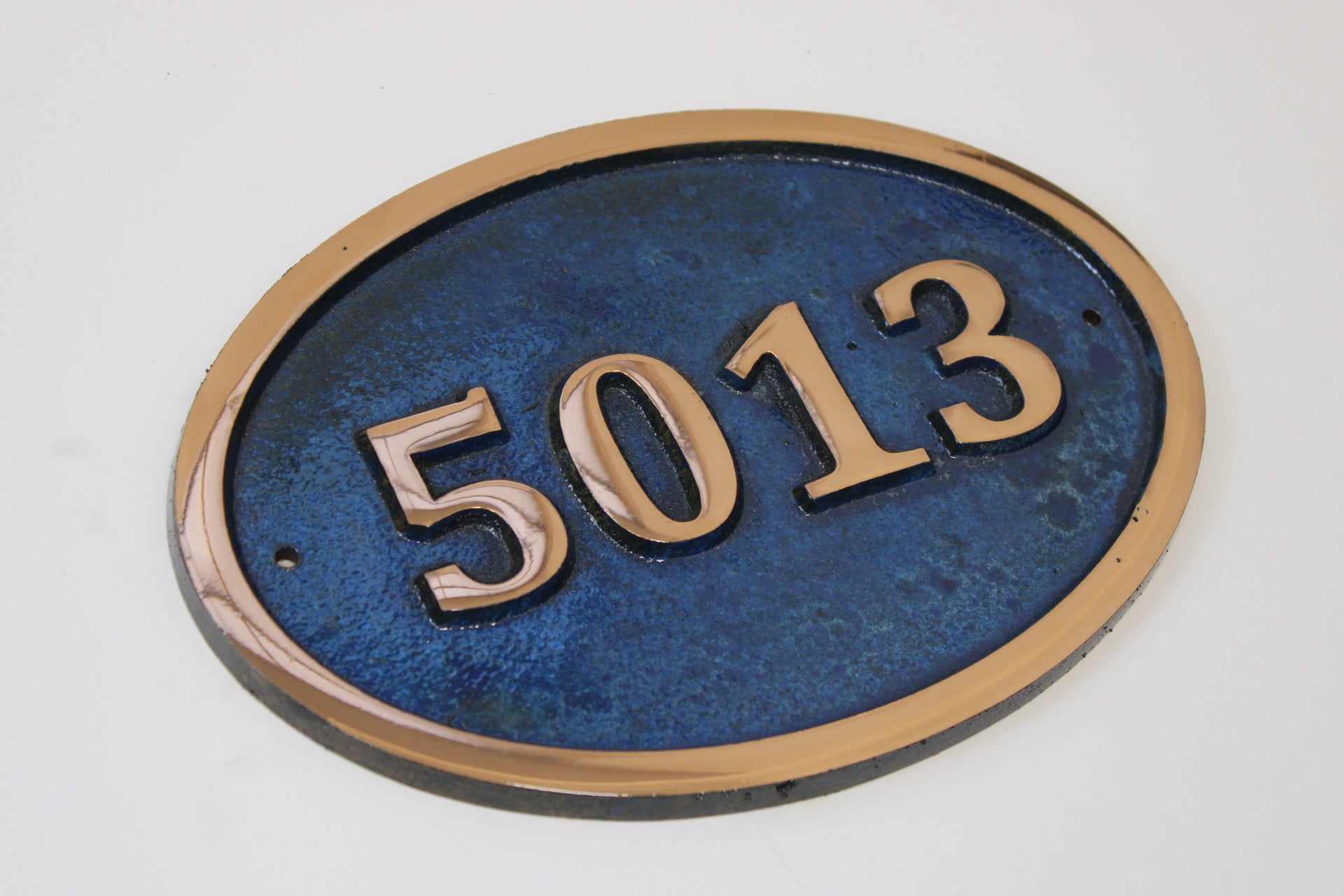 House number sign in Cast Copper blue background 