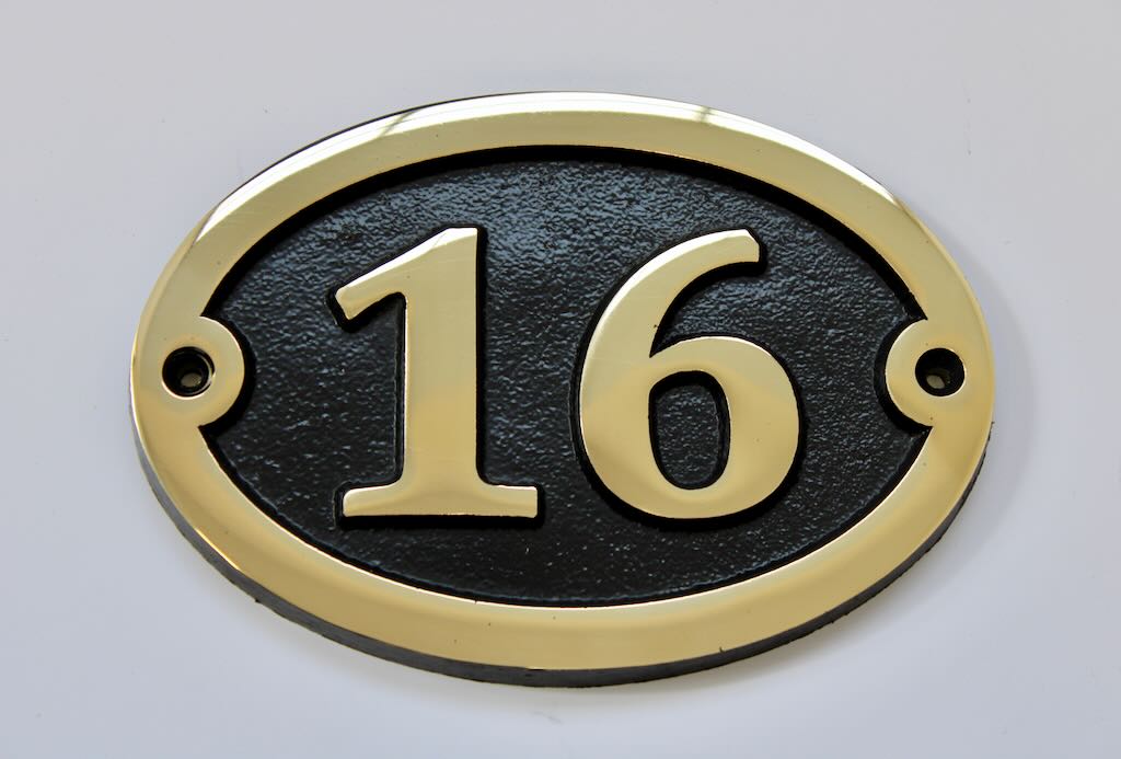 house number sign in bronze oval shape