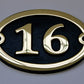 house number sign in bronze oval shape