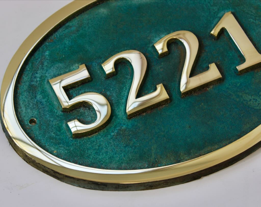 House number sign oval in bronze with Verdigris background