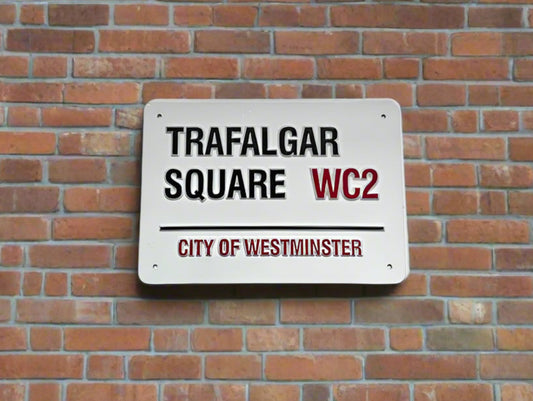 Street sign for Trafalgar Square WC2 on a brick wall
