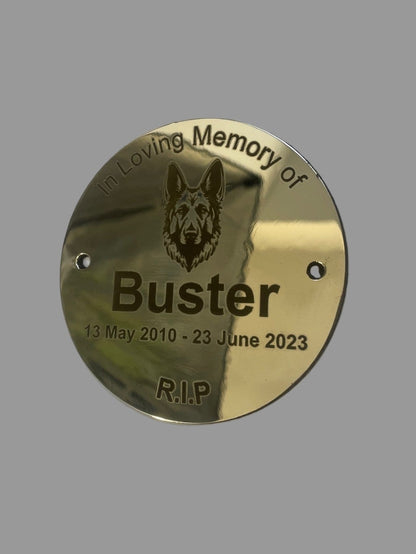 Gold plaque with a dog's face and text 'In Loving Memory of Buster' on a gray background