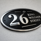 Wide oval aluminium house sign custom cast address plaque on wall