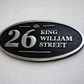 Wide oval aluminium house sign custom cast address plaque on wall