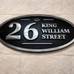Wide oval aluminium house sign custom cast address plaque on wall
