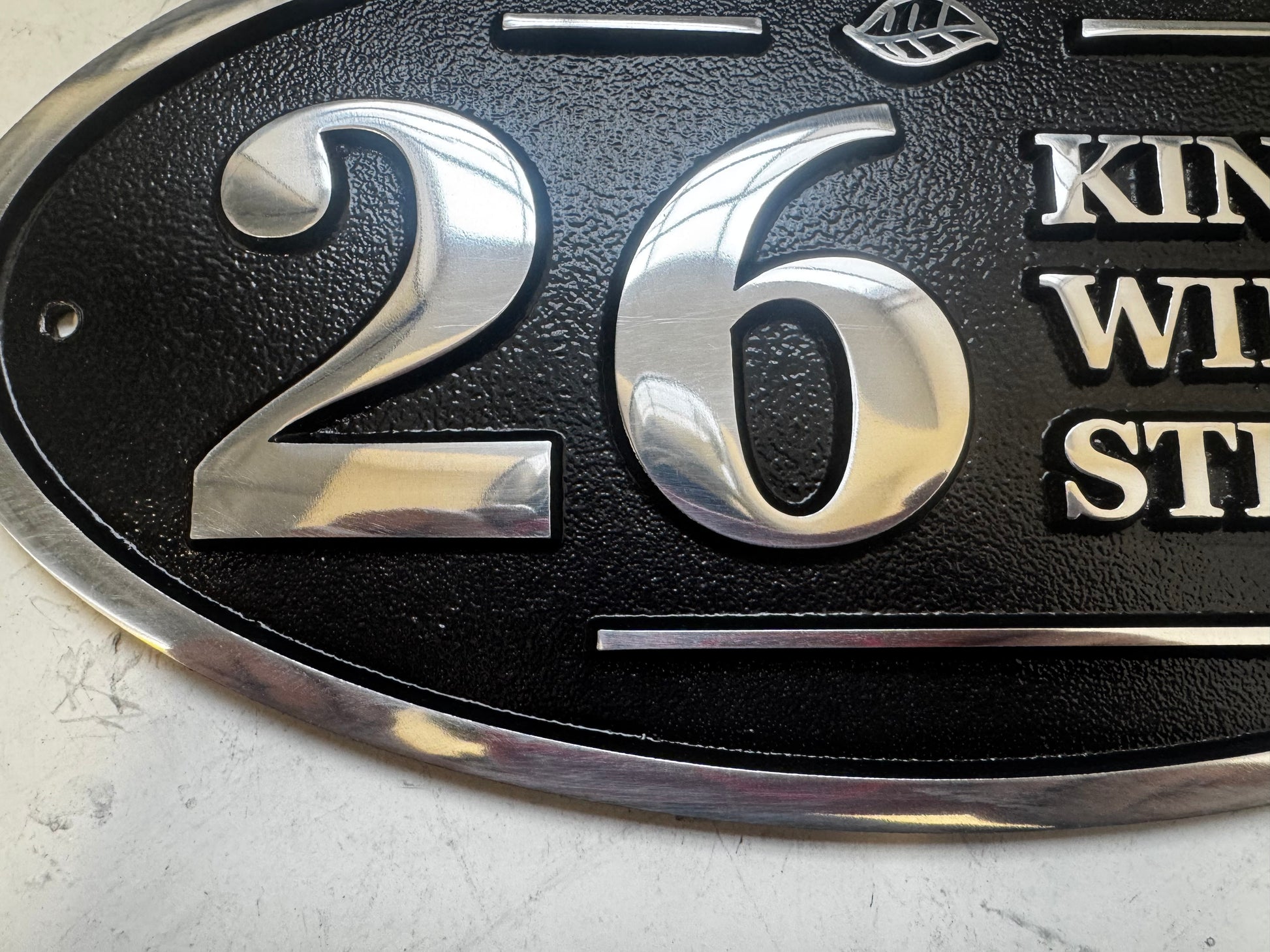 Wide oval aluminium house sign custom cast address plaque on wall