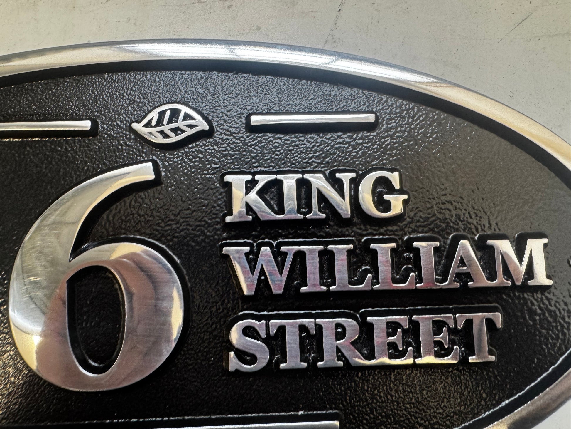 Wide oval aluminium house sign custom cast address plaque on wall