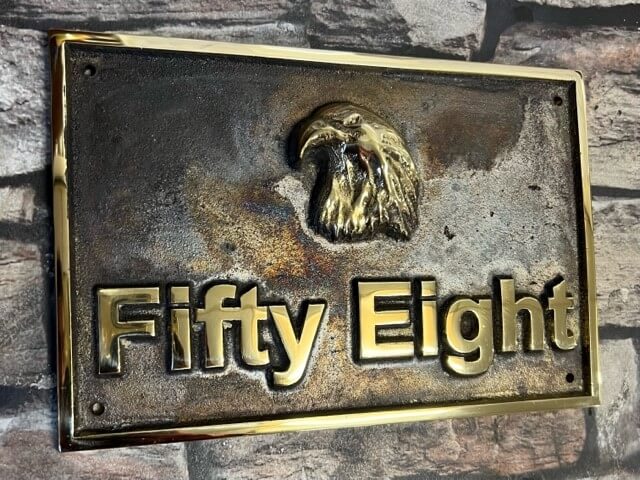 house plaque in bronze rainbow patina