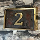 house number sign in aluminium patina background