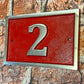 house number sign in aluminium red background