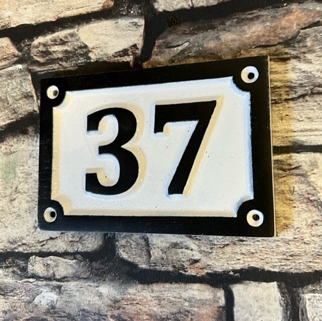 black and white house number sign