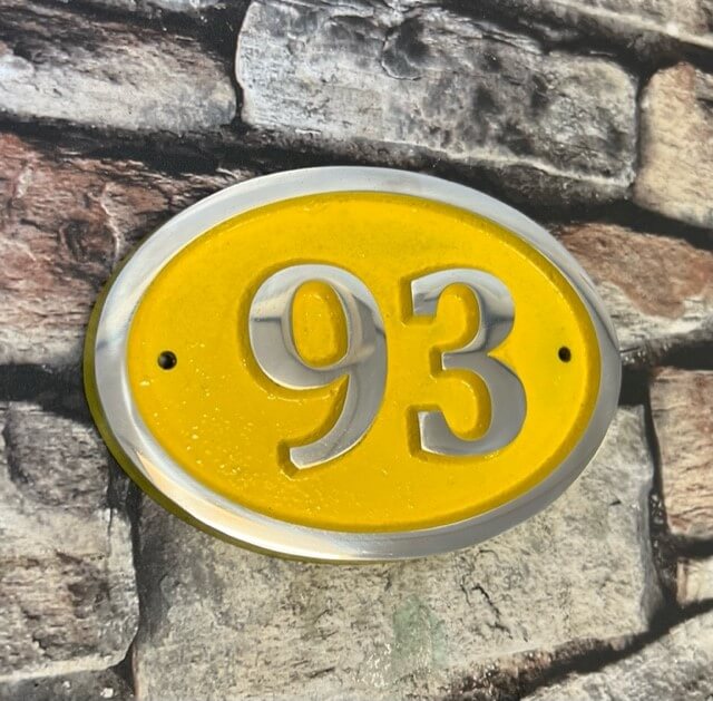 house number sign oval in yellow