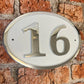 house number sign oval white background
