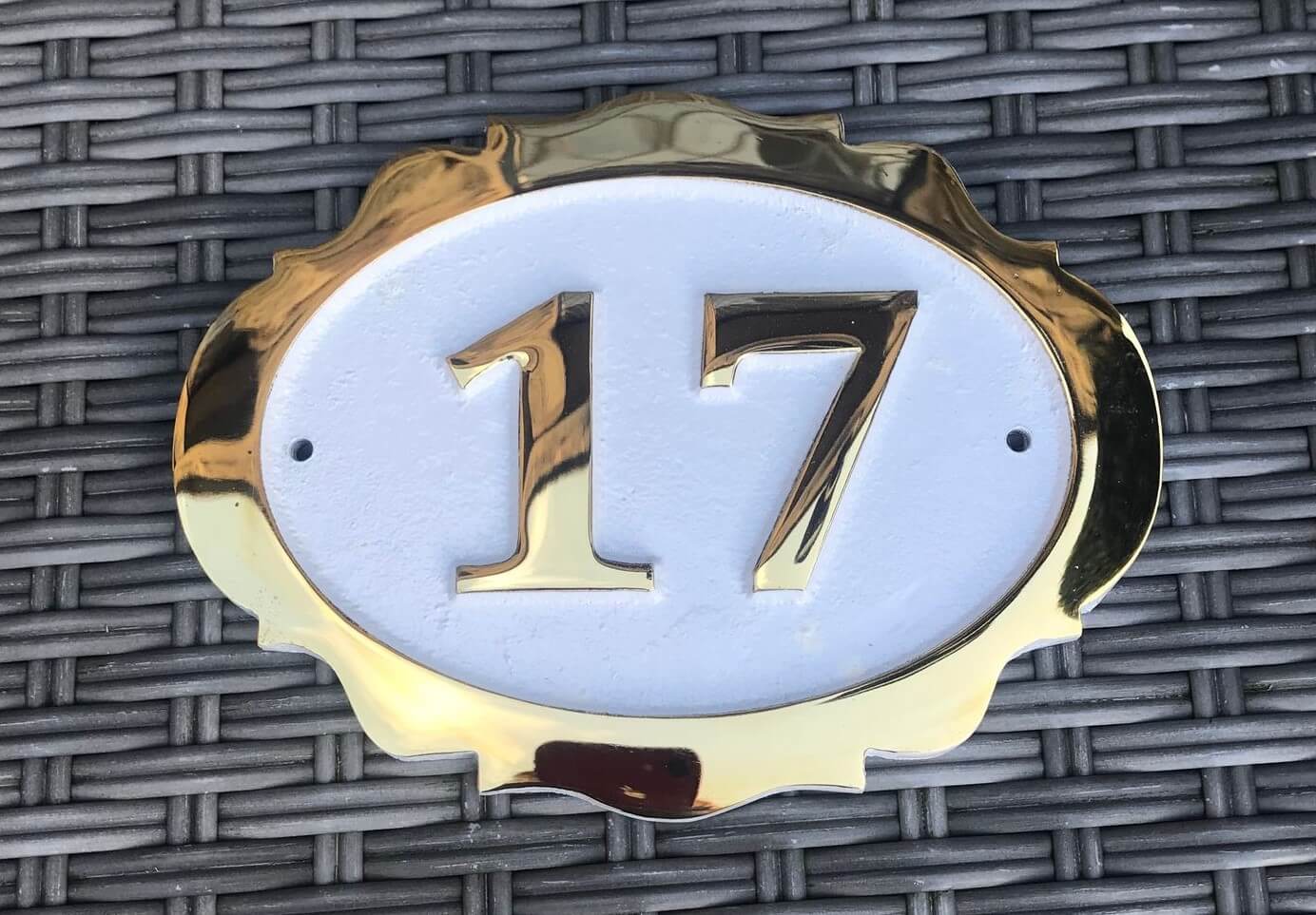 Fancy oval bronze number sign in white