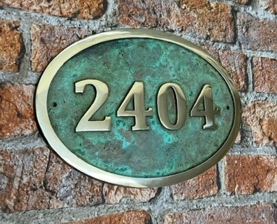 House number sign oval in bronze with Verdigris background