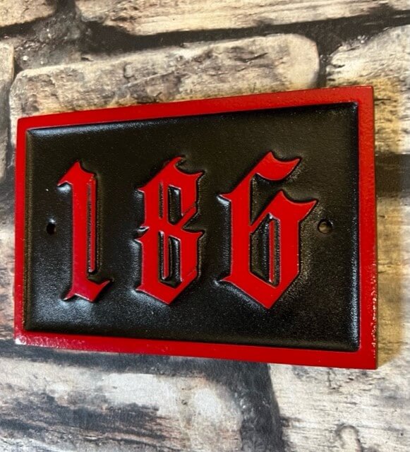 red and black house number sign