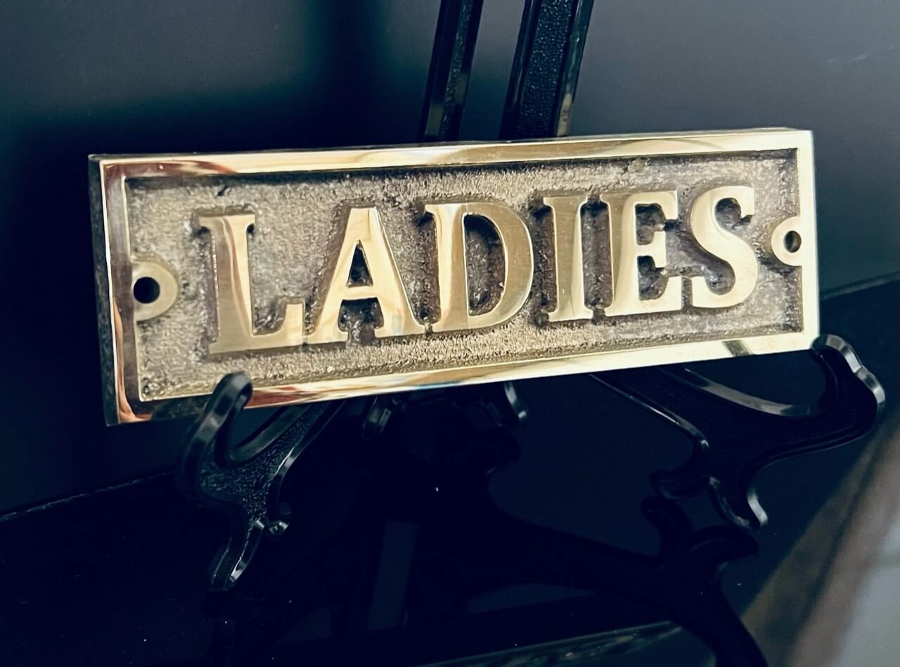 Toilet signs in bronze ladies
